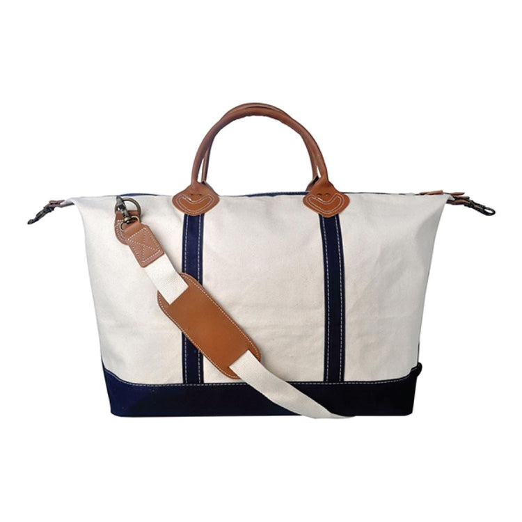 White bag with brown handles and strap on a white background