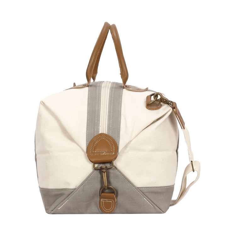 Canvas bag with brown leather accents on a white background