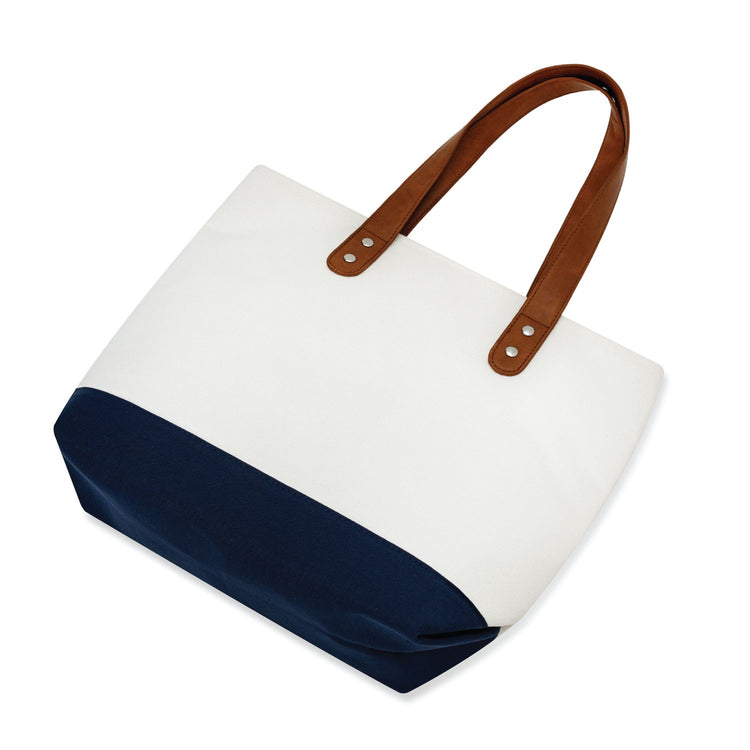 White tote bag with brown handles and navy bottom section on a white background