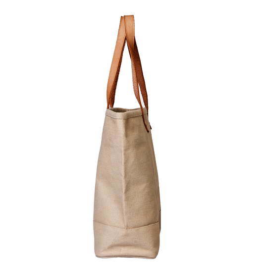 Beige tote bag with brown leather straps on a white background