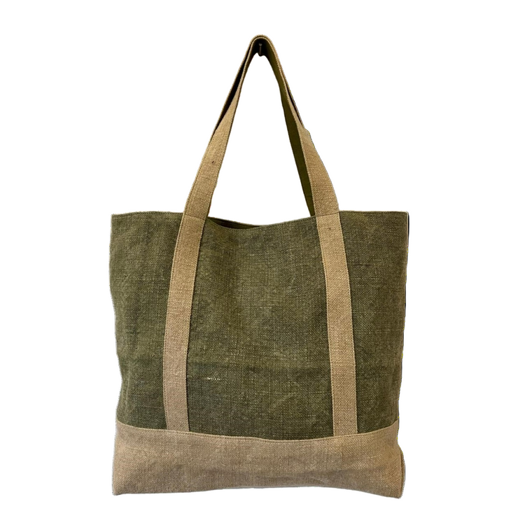 Green tote bag with brown handles on a light stone background