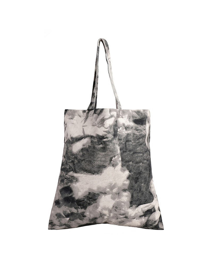 Tote bag with a black and white abstract pattern on a white background
