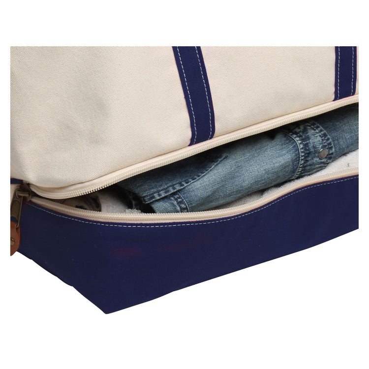 Blue suitcase with a white interior containing rolled-up jeans on a white background
