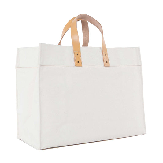 White tote bag with beige handles on a white background