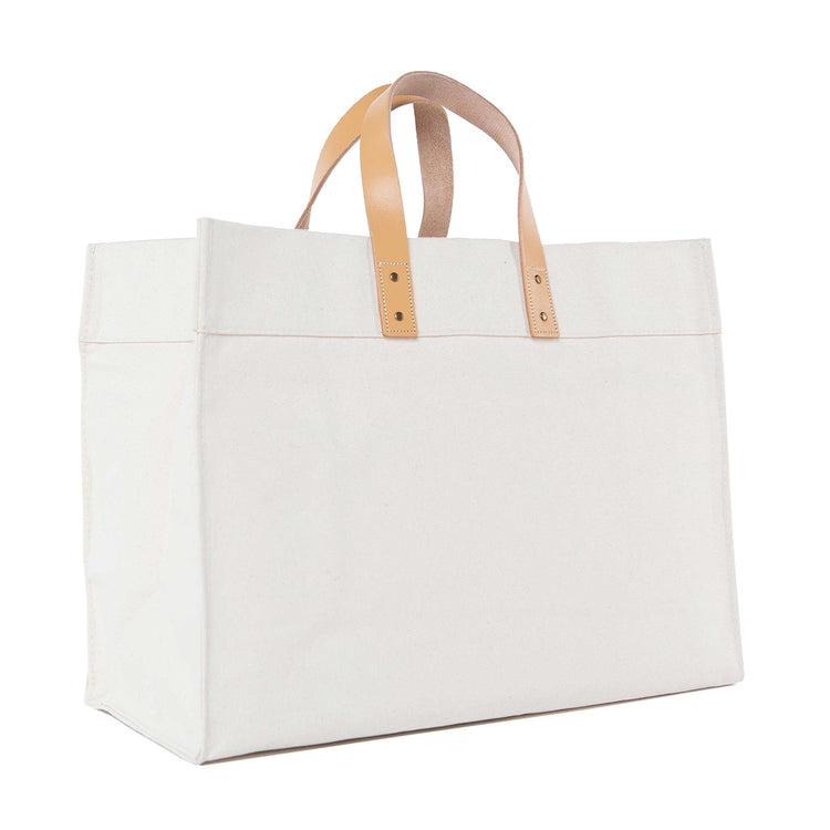 White tote bag with beige handles on a white background