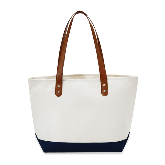 White tote bag with brown handles and navy bottom section on a white background